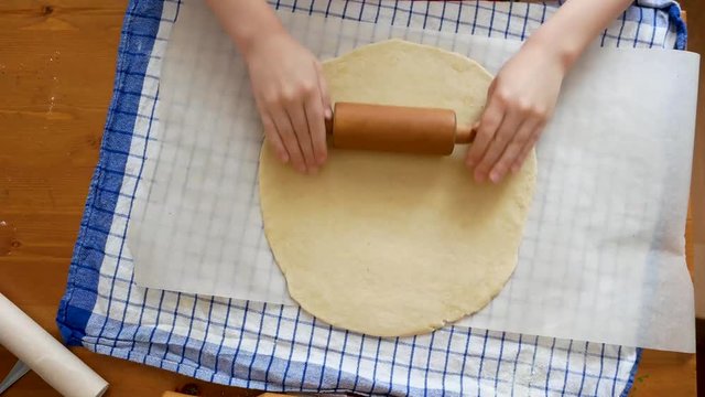 Making pizza or pide dough by close up girl hands in pastry kitchen, shaping dough is precursor to making a wide variety of food stuffs, particularly breads, biscuits, cakes, cookies, dumplings, pasta