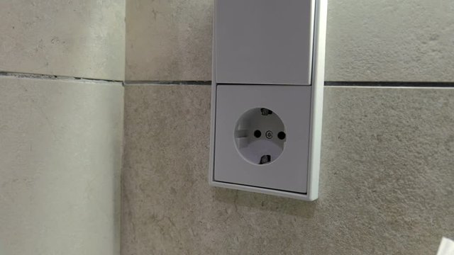 Male hand disconnecting power plug  