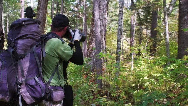 Young man takes picture of beautiful Sikhote-Alin Nature Reserve forest. Russia