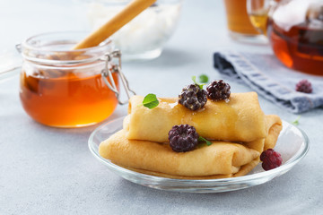 Ricotta stuffed crepes with honey, blackberries and mint.