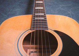 Obraz premium acoustic guitar on blue marble background,music concept.