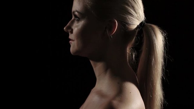 Portrait of a young woman in profile. Dynamic light