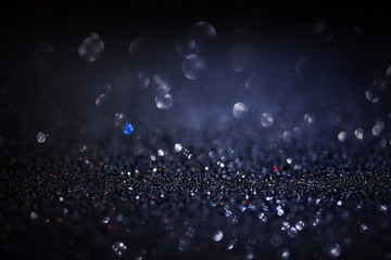 Dark glitter magic background. Defocused light and free focused place for your design.