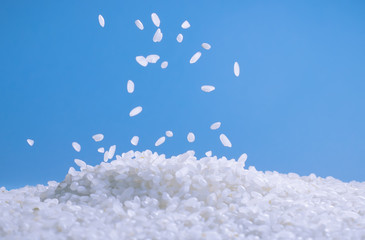lying on the table a white figure on a blue background spilling some of the rice