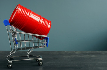 Shopping cart and Barrel with oil as symbol of trading.