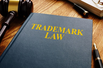Trademark law and gavel on a wooden surface. Copyright concept. - obrazy, fototapety, plakaty