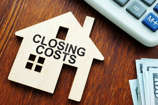 Closing costs. Model of house and money.