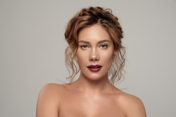 Fototapeta premium Brunette Girl with Long Healthy and Shiny Curly Hair. Care and Beauty. Beautiful Model Woman with Wavy Hairstyle