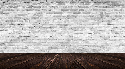background of an empty white room, a cellar, lit by a searchlight. Brick white wall and wooden floor