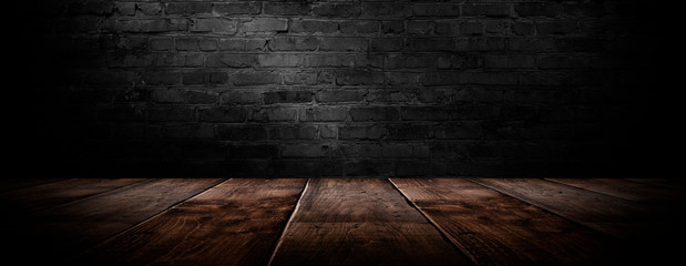 background of an empty black room, a cellar, lit by a searchlight. Brick black wall and wooden floor