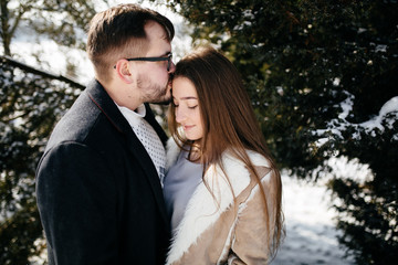 Young Beautiful Couple Taking Fun and Smiling Outdoors in Snowy Winter