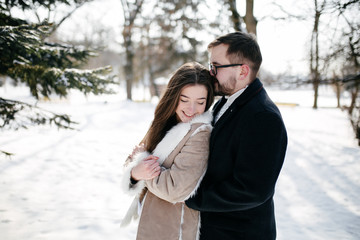 Young Beautiful Couple Taking Fun and Smiling Outdoors in Snowy Winter