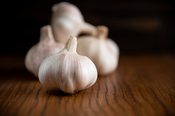 Garlic bulb on the wooden vintage background