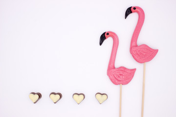 Lollipops in the form beautiful flamingo and chocolate hearts