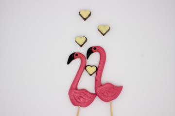 Lollipops in the form beautiful flamingo and chocolate hearts
