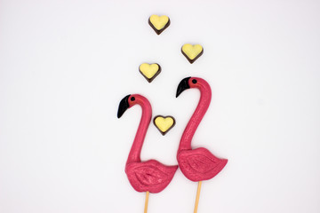 Lollipops in the form beautiful flamingo and chocolate hearts
