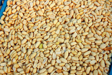  peeled raw peanuts in the market. pile of nuts