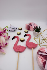 Composition from lollipops, chocolate hearts, pyramid, flower pot, and other decoration