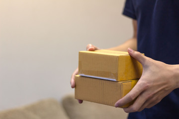 Man's hands holding the  carton box - courier and delivery service concept.