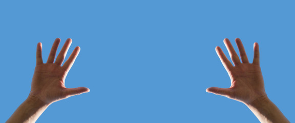 Two hands stretched up into the blue sky, long banner