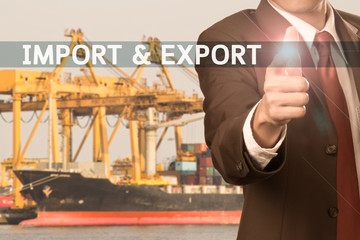 business man pointing finger to word - import & export