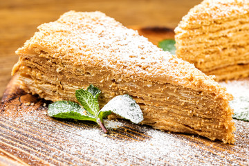 Slice of sweet classic layered cake Napoleon.