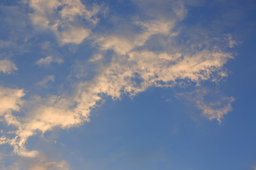 Fototapeta na wymiar beautiful clear blue sky with golden sunshine on fluffy cloud