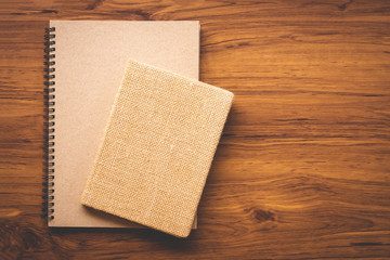 Notebook mock up design template isolated on wooden table background.