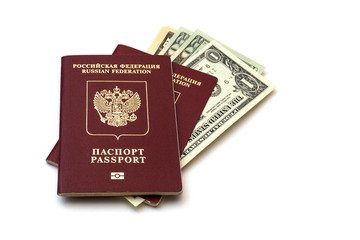 Isolated Russian passports and a pack of American dollars on white background
