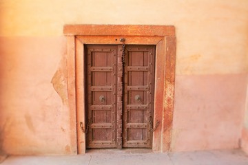 Fototapeta premium old wooden door in stone wall