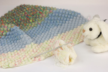 crochet work to make a baby blanket isolated on white
