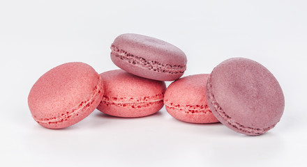 Delicious four pink macarons or macaroons isolated on a white background