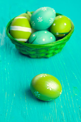 Green Easter eggs on wooden table