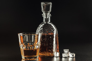 Glass of the whiskey and a square decanter