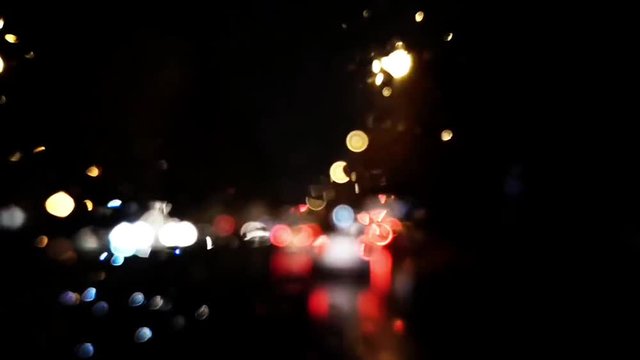 Defocused footage with cars and city lights in traffic.