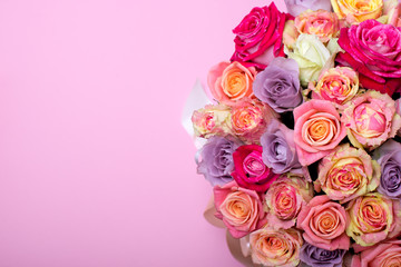 Beautiful bouquet of roses in a gift box. Bouquet of pink roses. Pink roses close-up. on pink background, with space for text.