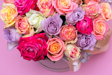 Beautiful bouquet of roses in a gift box. Bouquet of pink roses. Pink roses close-up. on pink background, with space for text.