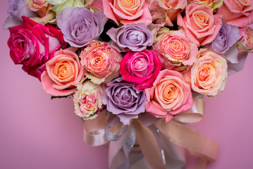 Beautiful bouquet of roses in a gift box. Bouquet of pink roses. Pink roses close-up. on pink background, with space for text.