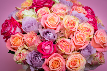 Beautiful bouquet of roses in a gift box. Bouquet of pink roses. Pink roses close-up. on pink background, with space for text.