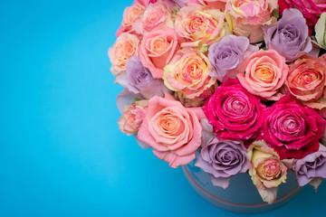 Beautiful bouquet of roses in a gift box. Bouquet of pink roses. Pink roses close-up. on blue background, with space for text.