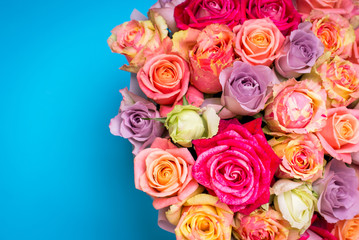 Beautiful bouquet of roses in a gift box. Bouquet of pink roses. Pink roses close-up. on blue background, with space for text.