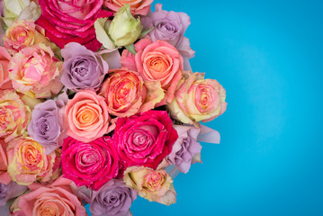 Beautiful bouquet of roses in a gift box. Bouquet of pink roses. Pink roses close-up. on blue background, with space for text.