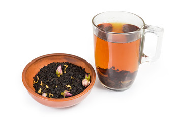Cup of black tea, tea leaves with chinese rose buds
