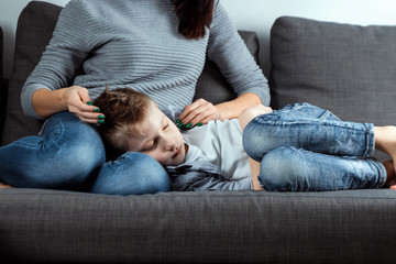 The boy is lying on the couch with an abdominal pain near his mother. The concept of custody,...