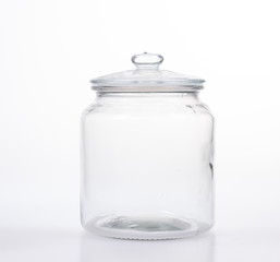 Glass jar with lid on white background