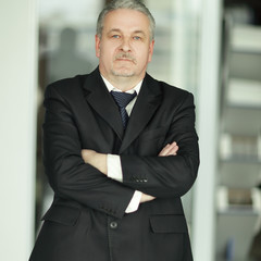 strict businessman on background of office.photo with copy space
