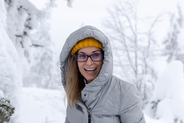 Hapopy tourist lady in her winter holiday in the mountains