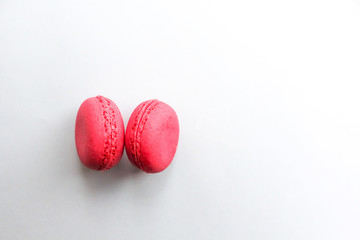 Two pink macaroons on a blue background, minimal food concept