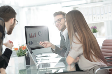 business team discusses the financial documents in the office