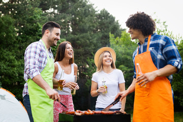 Group of friends having a barbecue party in nature